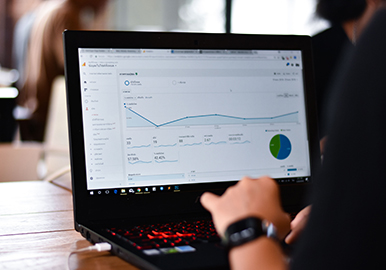 Person reviewing a website Google Analytics dashboard on a laptop